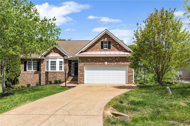 view of front of property featuring brick siding, a front lawn, an attached garage, and driveway