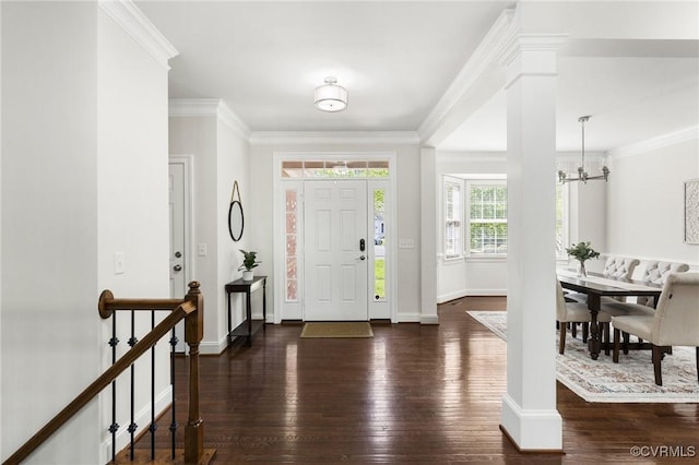 foyer entrance with baseboards, a chandelier, ornamental molding, and hardwood / wood-style flooring