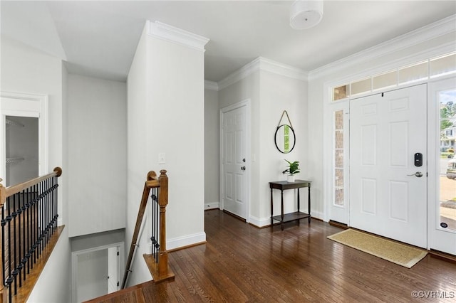foyer entrance featuring crown molding, baseboards, and wood finished floors