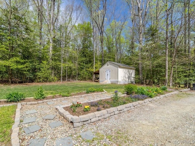 2004 Westwood Ct, Powhatan, VA 23139 - view of grassy yard with a storage shed, an outdoor structure, and a forest view