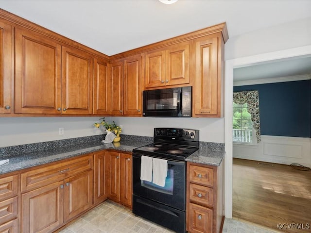 2004 Westwood Ct, Powhatan, VA 23139 - kitchen featuring black appliances, brown cabinets, ornamental molding, wainscoting, and dark stone countertops