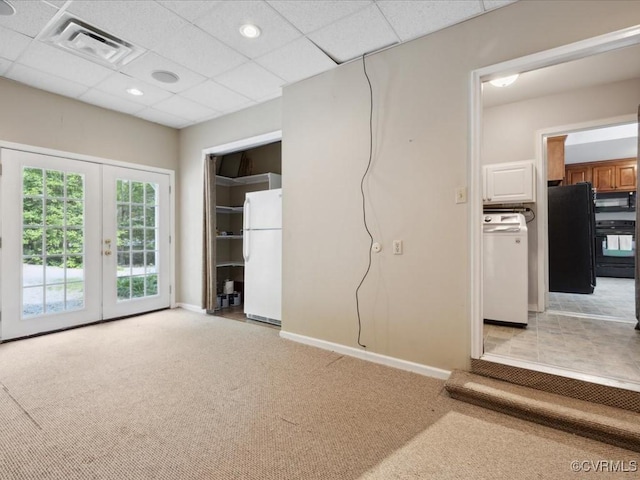 2004 Westwood Ct, Powhatan, VA 23139 - unfurnished living room with light carpet, french doors, washer / clothes dryer, baseboards, and a paneled ceiling