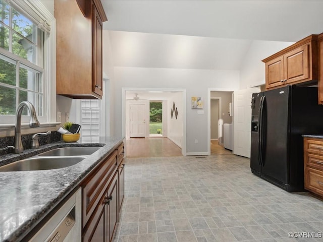 2004 Westwood Ct, Powhatan, VA 23139 - kitchen featuring black fridge, a sink, washer and dryer, dishwasher, and vaulted ceiling