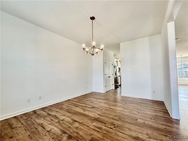10001 Craftsbury Dr, Midlothian, VA 22312 - unfurnished dining area with a chandelier, wood finished floors, and baseboards