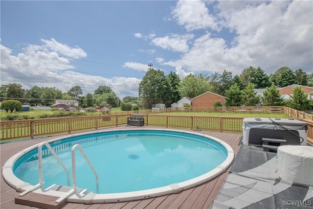 view of swimming pool with a hot tub and a deck