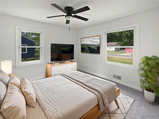 bedroom with baseboards, multiple windows, carpet, and visible vents