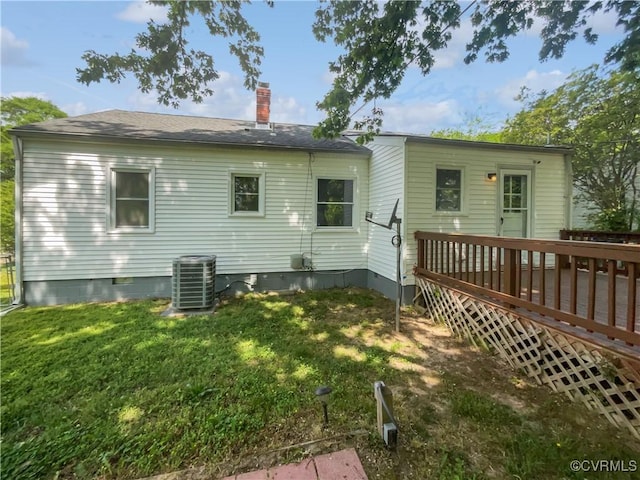 rear view of house with a deck, cooling unit, a chimney, crawl space, and a yard