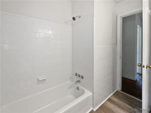 bathroom with shower / washtub combination and wood finished floors