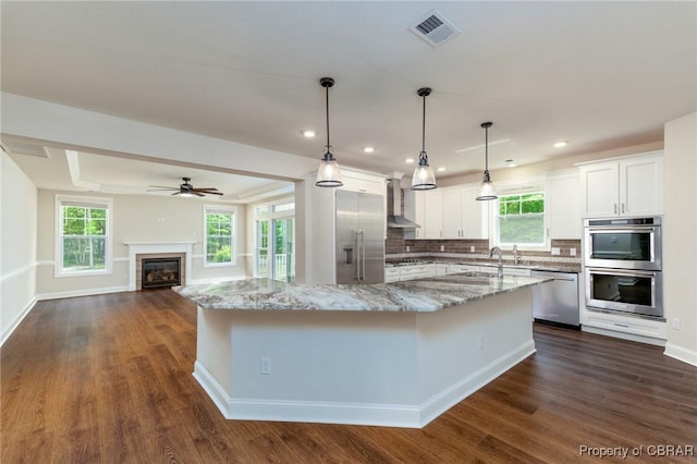 11264 Rivers Edge Ter, Gloucester, VA 23061 - kitchen with visible vents, white cabinetry, a large island with sink, dark wood finished floors, and stainless steel appliances