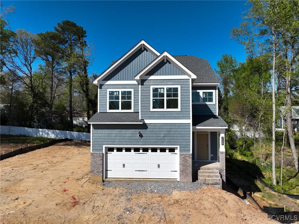 7960 Lyndale Dr, Chesterfield, VA 23235 - view of front facade with brick siding, an attached garage, and driveway