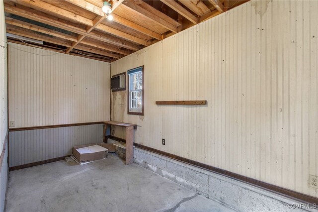 basement featuring a wall mounted air conditioner
