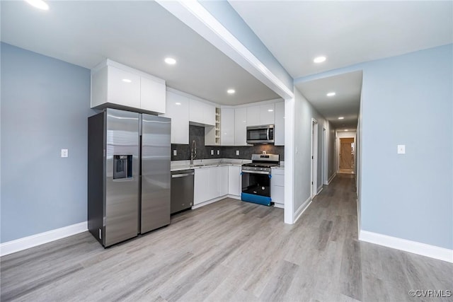 512 Pollock St, Richmond, VA 23222 - kitchen with a sink, light countertops, stainless steel appliances, white cabinetry, and modern cabinets