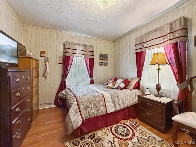 6266 Richmond Rd, Williamsburg, VA 23188 - bedroom featuring a textured ceiling, wood finished floors, and wooden walls