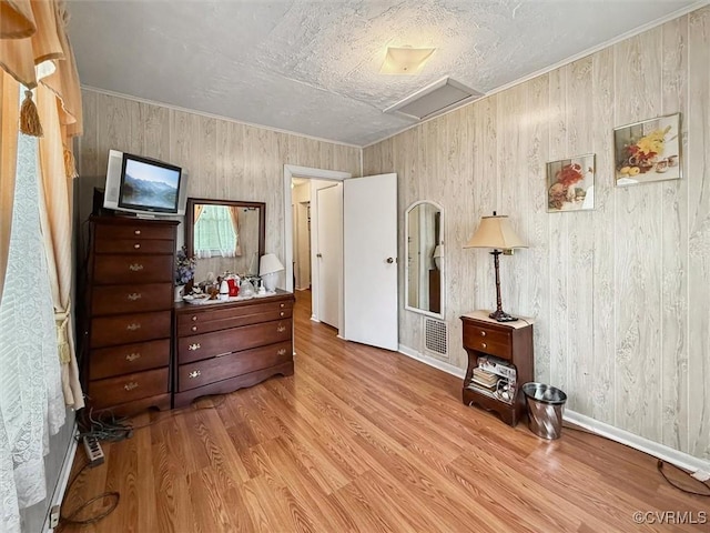 6266 Richmond Rd, Williamsburg, VA 23188 - bedroom with wooden walls, light wood-style floors, attic access, baseboards, and visible vents