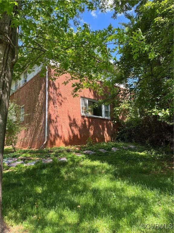 view of property exterior featuring brick siding