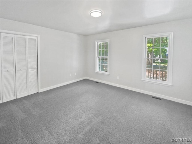 10901 Drayton Rd, Chester, VA 23831 - unfurnished bedroom featuring baseboards, multiple windows, a closet, and dark carpet