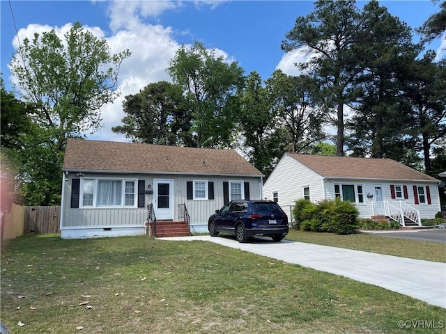 view of front of home with crawl space, fence, concrete driveway, a shingled roof, and a front lawn