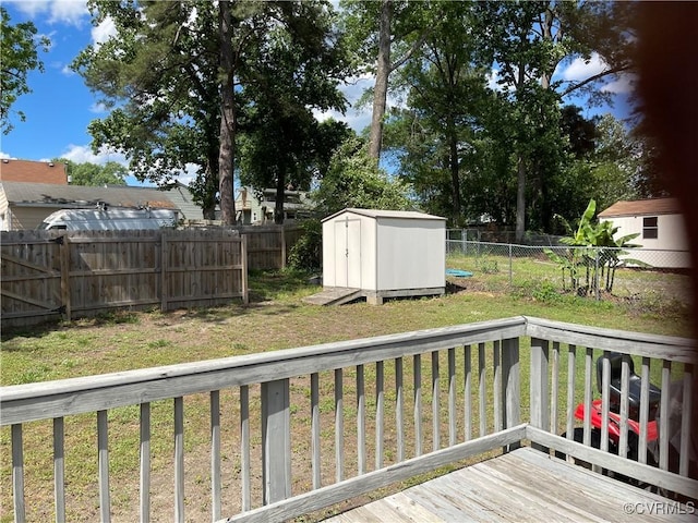 deck with a storage shed and an outbuilding