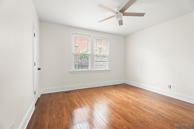 spare room with wood-type flooring, baseboards, and ceiling fan