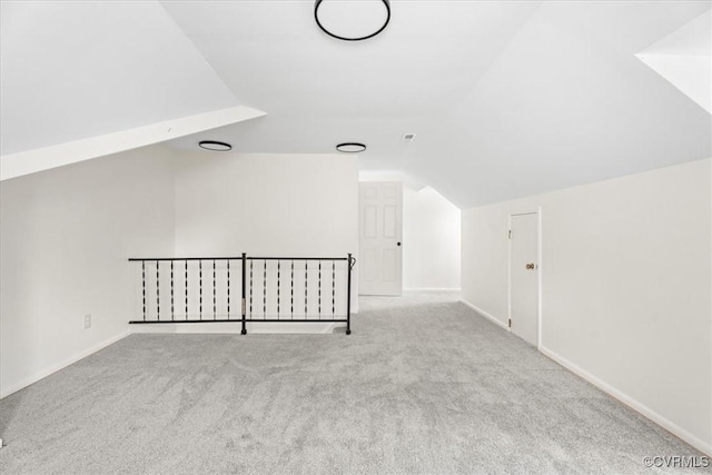 bonus room with baseboards, carpet flooring, and lofted ceiling