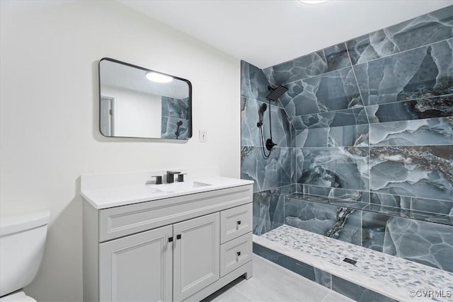 full bathroom featuring vanity, a walk in shower, and toilet