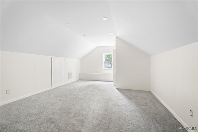 bonus room with visible vents, baseboards, carpet, and lofted ceiling