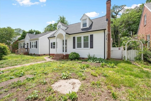 cape cod home featuring fence, a chimney, a shingled roof, and crawl space