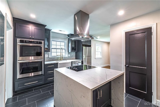 6503 W Grace St, Henrico, VA 23226 - kitchen featuring appliances with stainless steel finishes, island exhaust hood, a center island, plenty of natural light, and recessed lighting