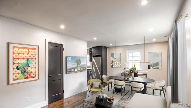 dining space with baseboards, recessed lighting, and wood finished floors