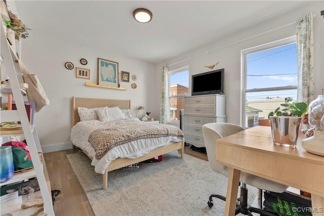 bedroom featuring baseboards and wood finished floors