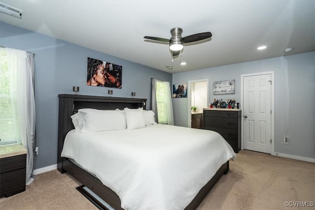 bedroom featuring baseboards, light colored carpet, and visible vents