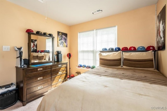 carpeted bedroom featuring visible vents and attic access