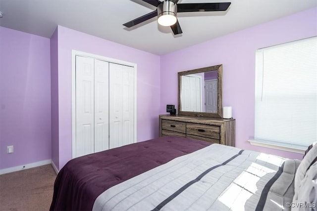 carpeted bedroom with a closet, a ceiling fan, and baseboards