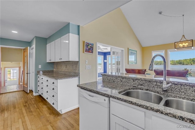2215 Ditchley Rd, Kilmarnock, VA 22482 - kitchen with white dishwasher, a sink, white cabinetry, light wood-style floors, and recessed lighting
