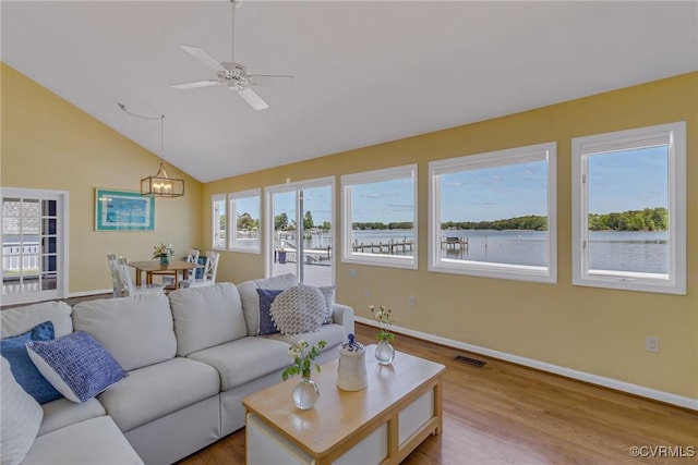 2215 Ditchley Rd, Kilmarnock, VA 22482 - living room featuring a chandelier, wood finished floors, baseboards, ceiling fan, and high vaulted ceiling