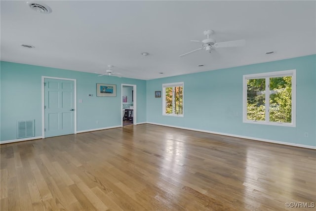 2215 Ditchley Rd, Kilmarnock, VA 22482 - unfurnished living room featuring ceiling fan, wood finished floors, and plenty of natural light