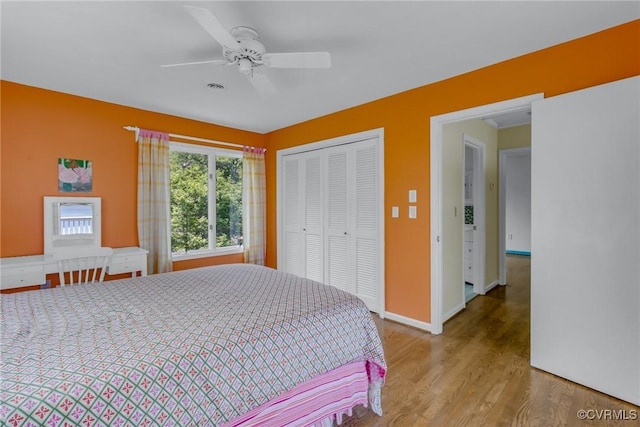 2215 Ditchley Rd, Kilmarnock, VA 22482 - bedroom featuring wood finished floors, a closet, baseboards, and a ceiling fan