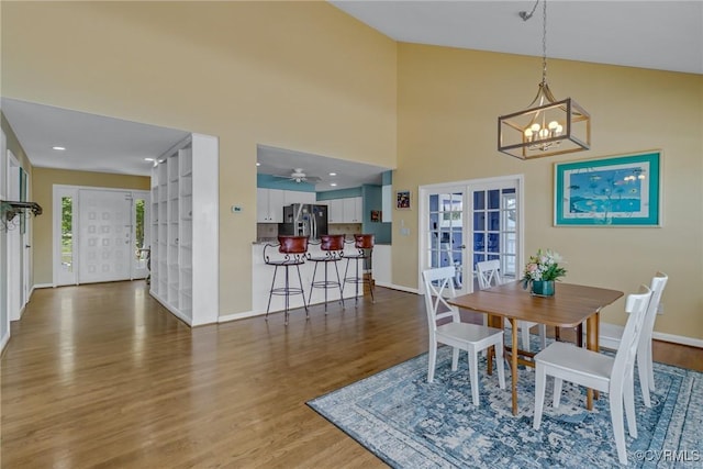 2215 Ditchley Rd, Kilmarnock, VA 22482 - dining room with french doors, wood finished floors, a chandelier, and baseboards