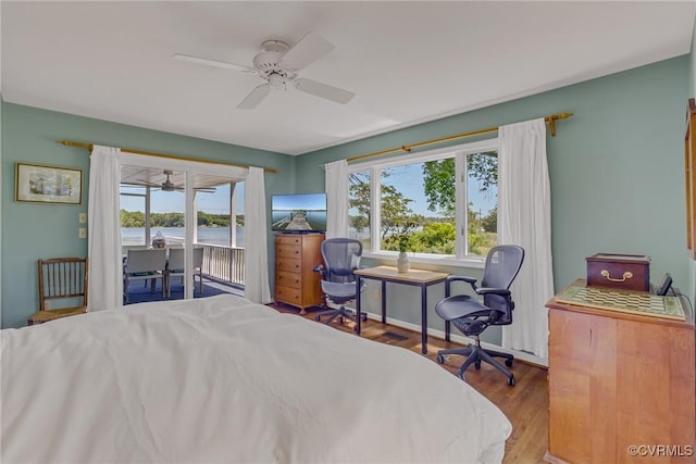 2215 Ditchley Rd, Kilmarnock, VA 22482 - bedroom featuring access to outside, multiple windows, wood finished floors, and ceiling fan