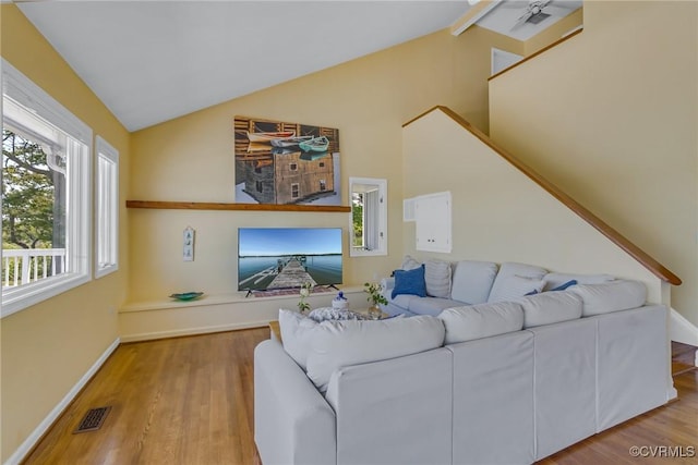 2215 Ditchley Rd, Kilmarnock, VA 22482 - living room featuring lofted ceiling, wood finished floors, and baseboards