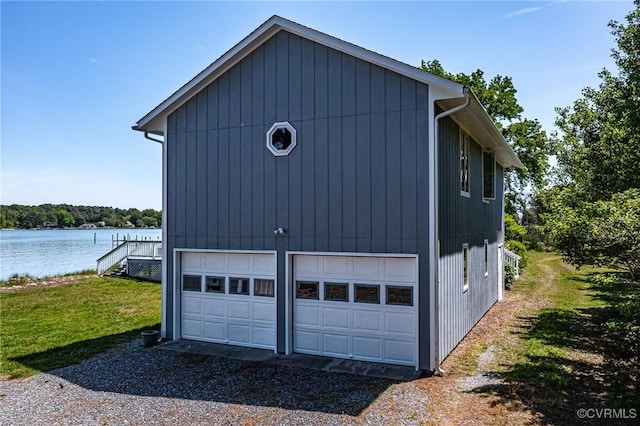 2215 Ditchley Rd, Kilmarnock, VA 22482 - view of side of home featuring a water view, a detached garage, and a lawn