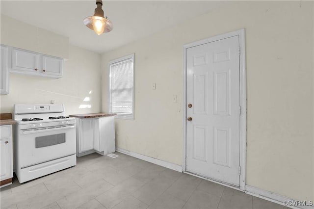 2111 Maplewood Ave, Richmond, VA 23220 - kitchen with white cabinetry, baseboards, and white gas range