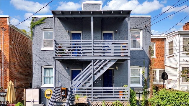 2111 Maplewood Ave, Richmond, VA 23220 - view of front of home with a deck, a chimney, stairway, and brick siding