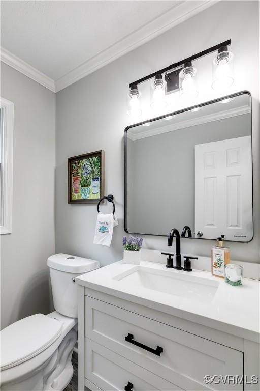 7713 Flag Tail Dr, Midlothian, VA 23112 - bathroom with ornamental molding, vanity, and toilet