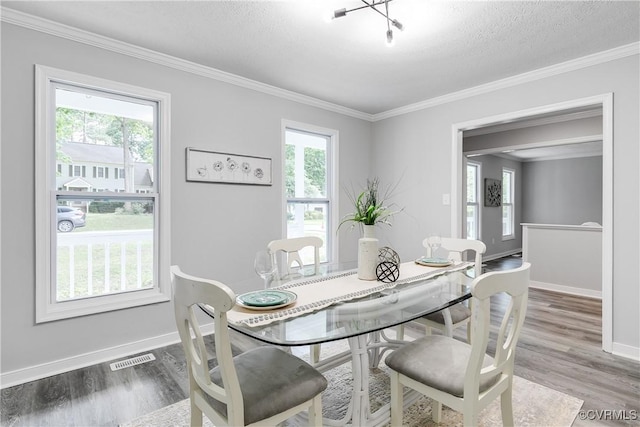 7713 Flag Tail Dr, Midlothian, VA 23112 - dining space featuring plenty of natural light, baseboards, wood finished floors, ornamental molding, and a textured ceiling