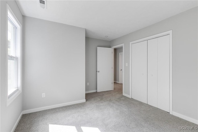 7713 Flag Tail Dr, Midlothian, VA 23112 - unfurnished bedroom with carpet floors, multiple windows, baseboards, and a closet