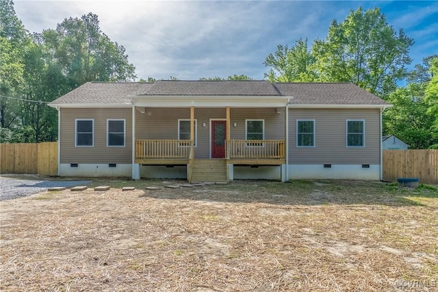 view of front of home featuring fence, covered porch, and crawl space