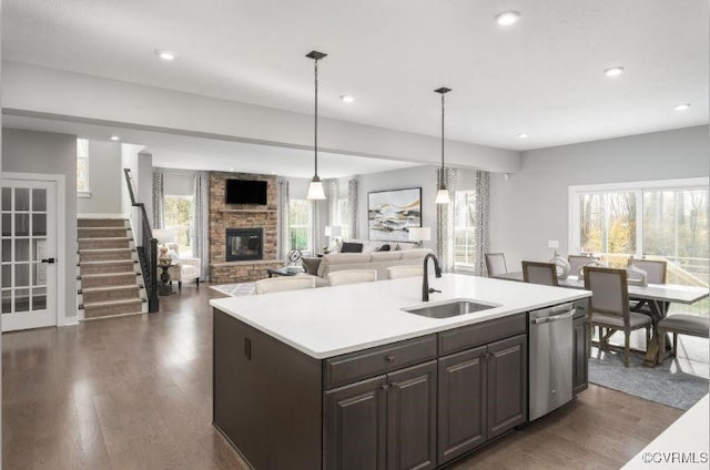 1 Abercrombie Dr, Chesterfield, VA 23838 - kitchen with dishwasher, a sink, a fireplace, dark wood finished floors, and light countertops