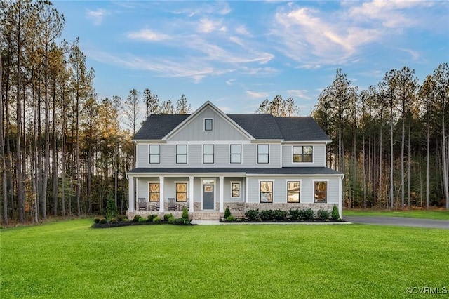 4 Abercrombie Dr, Chesterfield, VA 23838 - view of front facade featuring covered porch, board and batten siding, and a front lawn