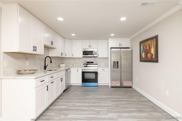 1701 Arlington Rd, Hopewell, VA 23860 - kitchen featuring visible vents, crown molding, light wood-style floors, a sink, and stainless steel appliances